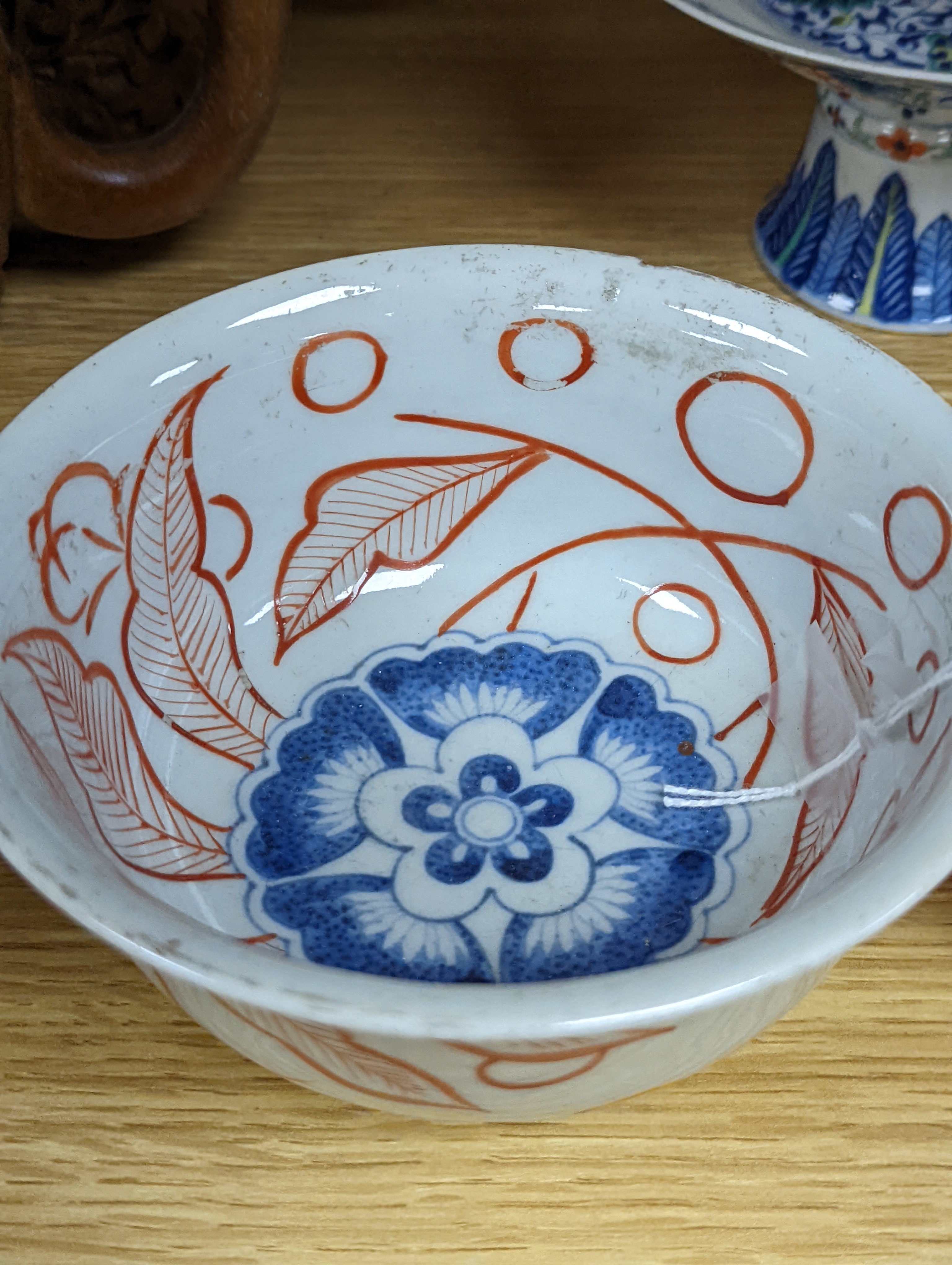 A Chinese blue and white water pipe vessel, a doucai stem dish and a Japanese Imari bowl, 19th century, (3)